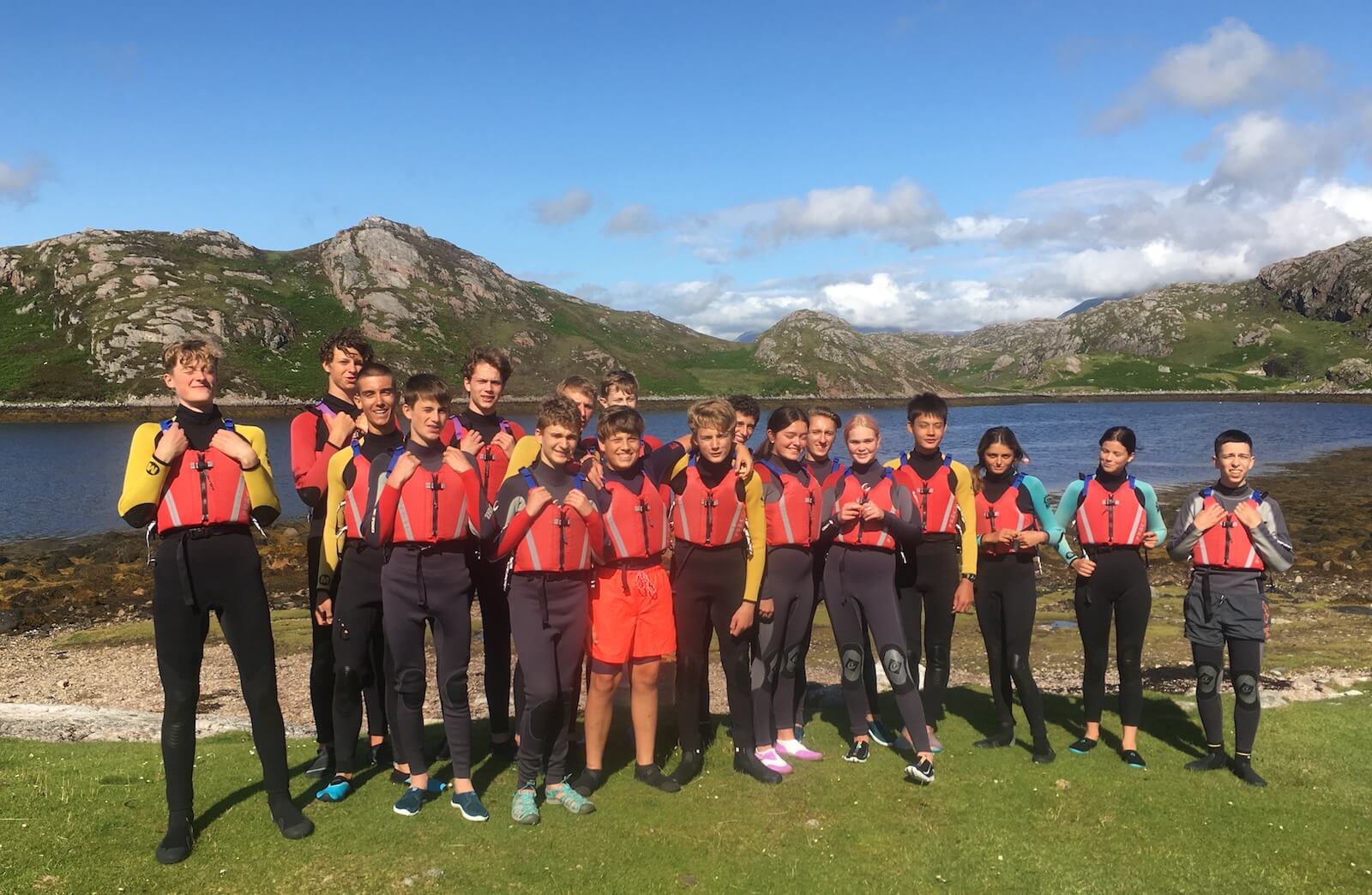 Group of young people go swimming in the sea at Ridgway Adventure