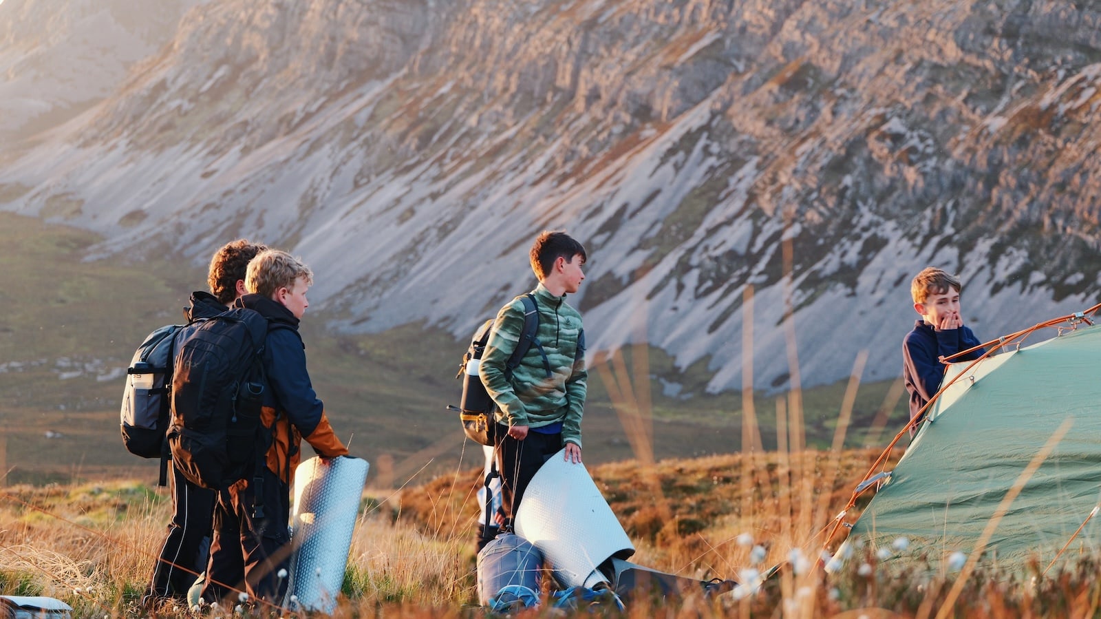 Schoolboys pitching a tent