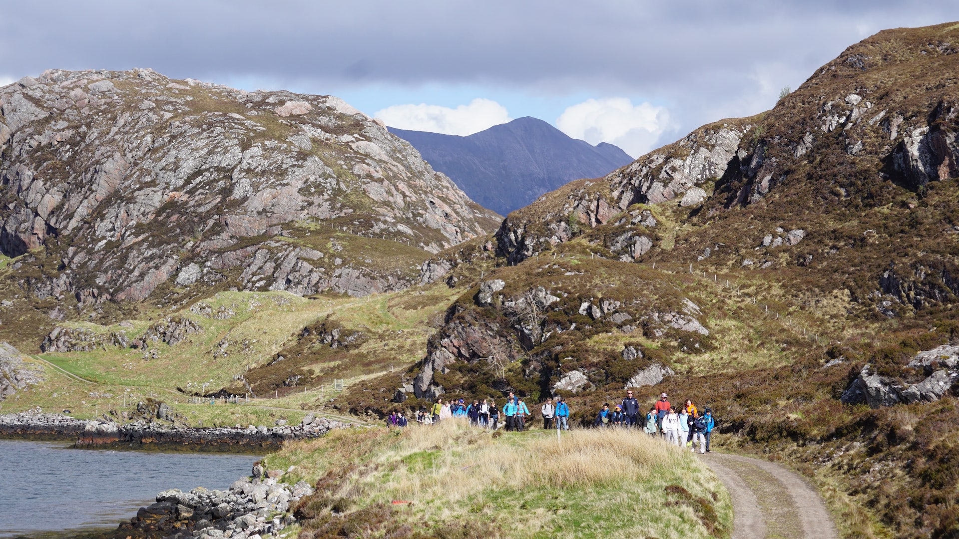Children walking with mountains behind