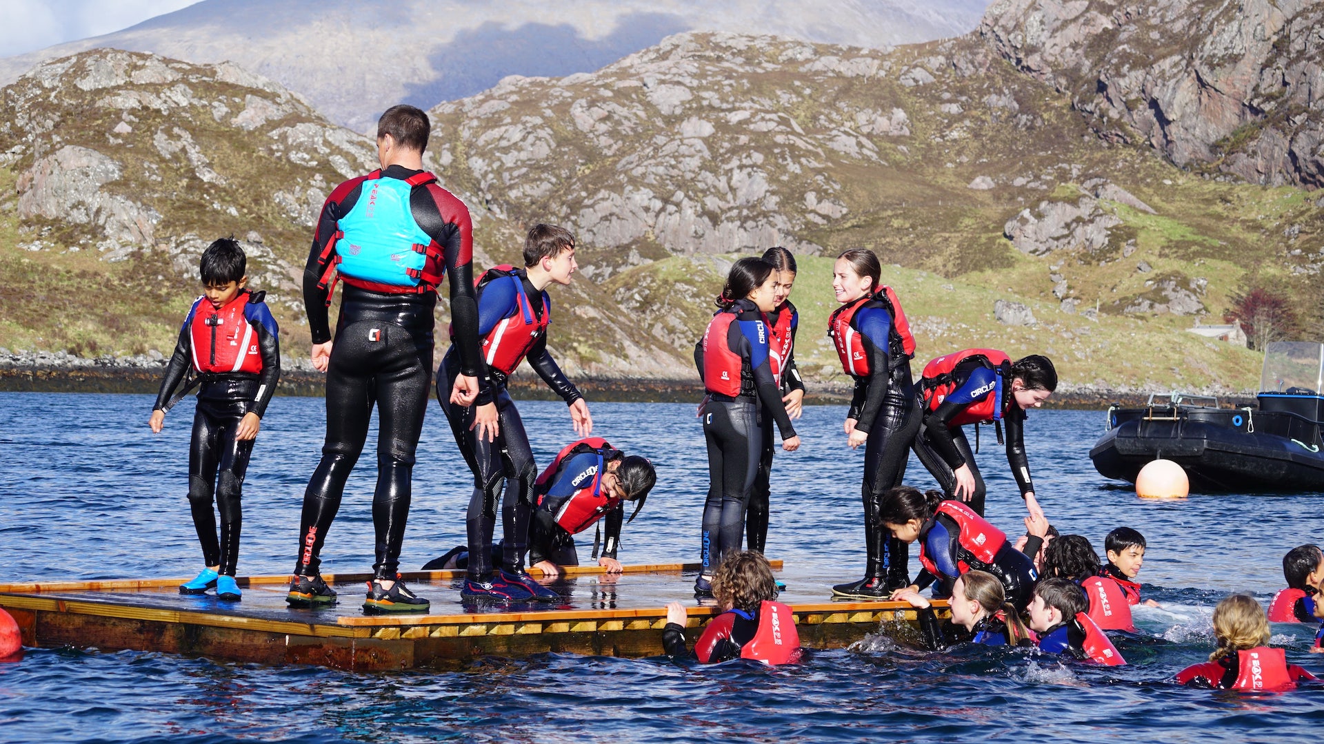 Children swimming in a sea loch