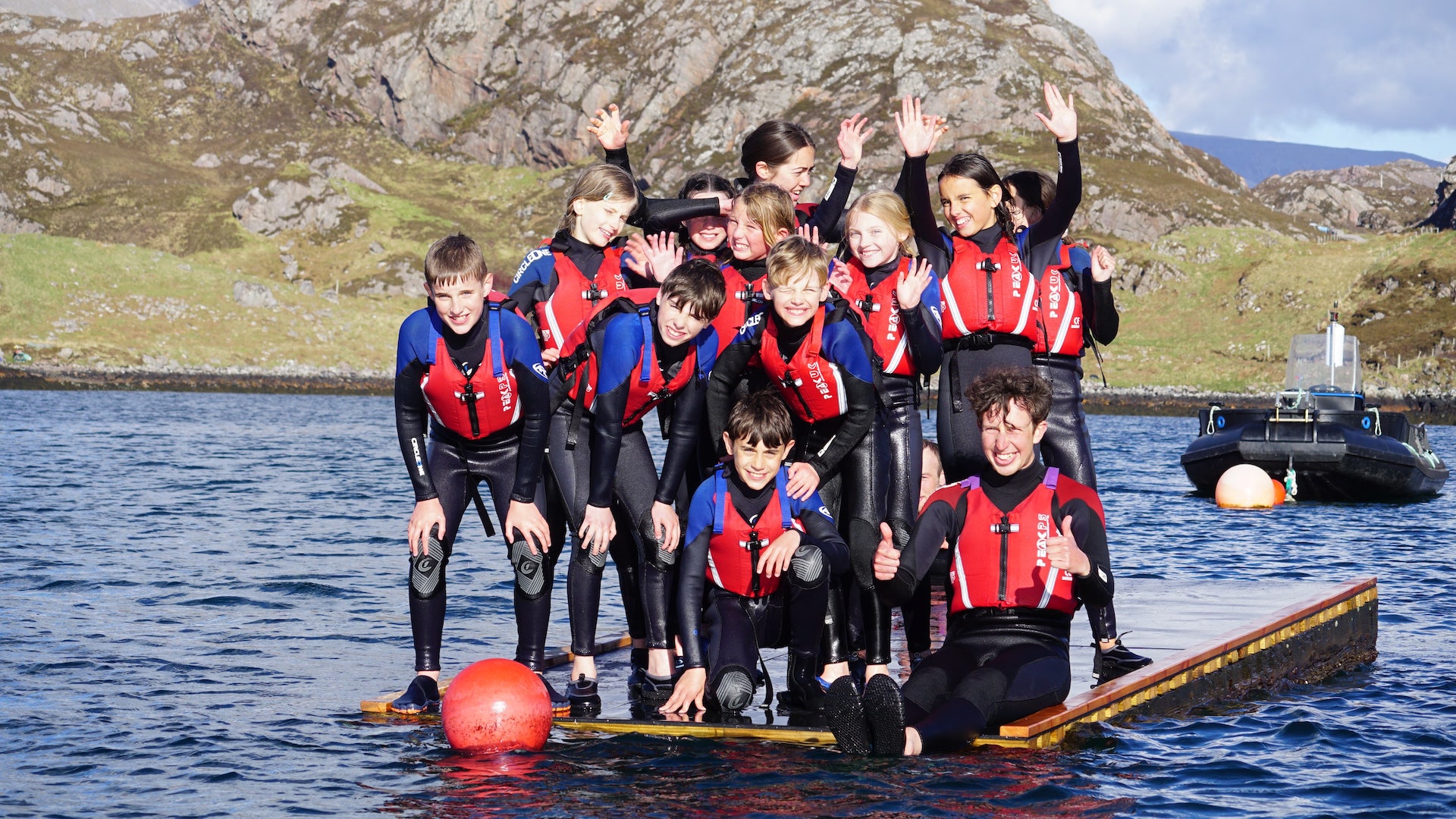 Children swimming to a raft